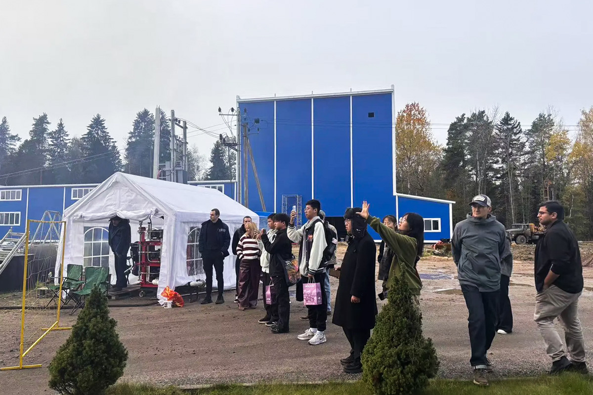 Guests observe a live demonstration of a lithium-ion battery fire being extinguished